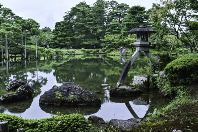 A Japanese garden style arranged around a large central pond