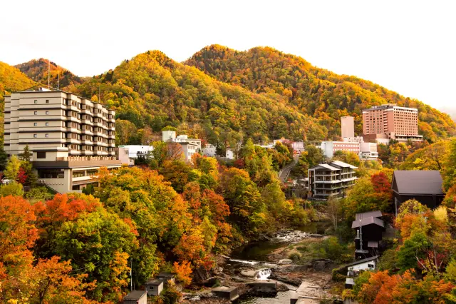 Take a stroll through Jozankei, surrounded by vibrant autumn foliage.