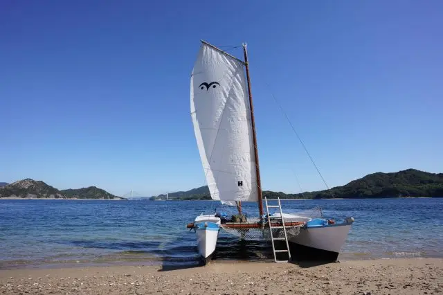 Weave around islands on a catamaran yacht and head for an uninhabited island