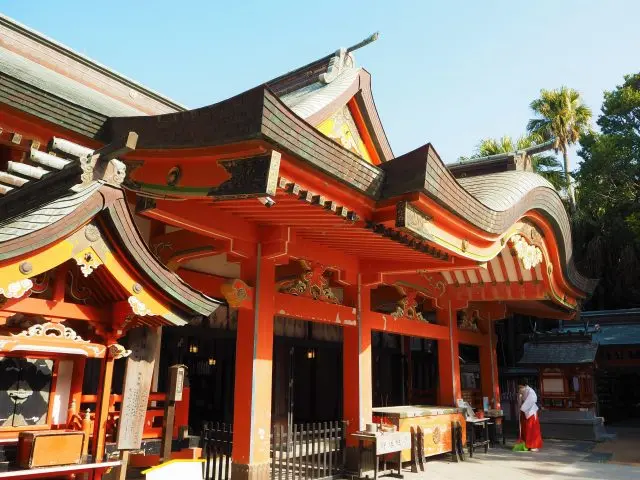 The vermilion shrine pavilion stands out against the blue sky