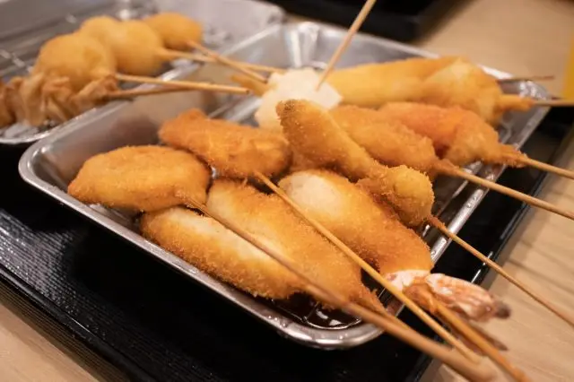 Freshly fried kushikatsu skewers, dipped in a delectable sauce.