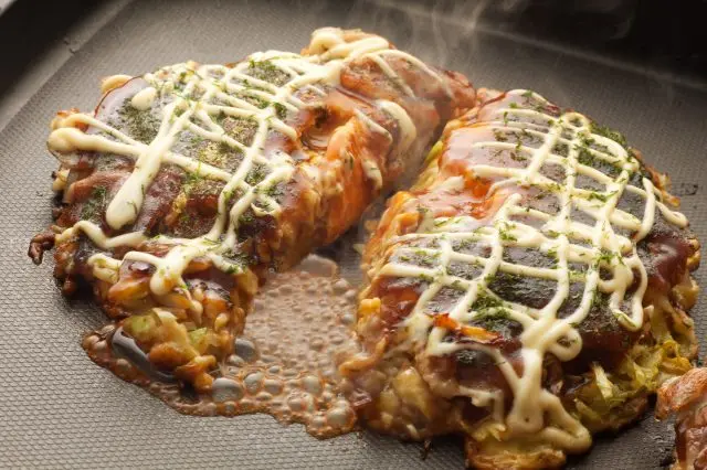 Okonomiyaki with its mouthwatering, saucy aroma.