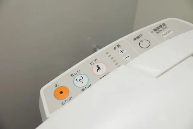 Typical buttons found on a heated water cleaning toilet seat.