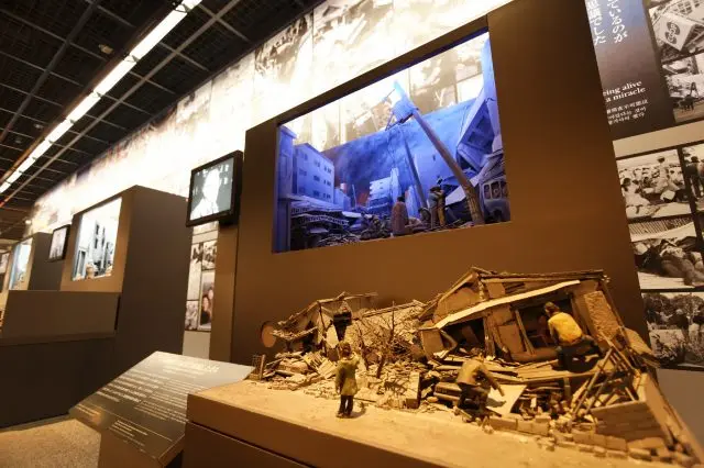 A diorama model illustrating the progressively rebuilt cityscape and homes is displayed in The Path to Reconstruction.