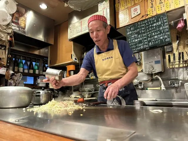 Watching the sheer skill as your okonomiyaki is made is half the fun.