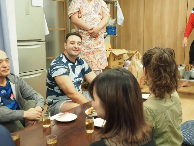 Unlike the intensity of practice, the stable master offers a warm greeting to the tour.