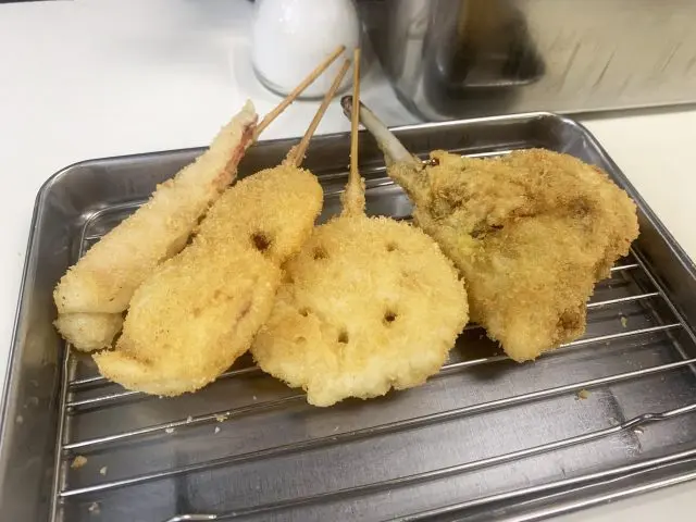 Located in the heart of Umeda with excellent access, Matsuba Sohonten is a beloved kushikatsu (skewered and fried food) restaurant cherished by the people of Osaka for its stand-and-eat style.