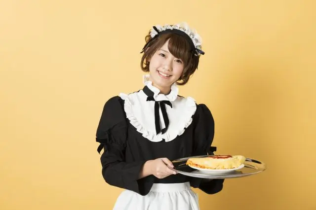 A cafe-style features maids in classical attire serving customers.