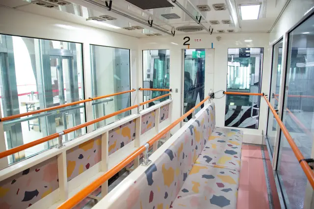 All seats face outward for optimal viewing through large glass windows.