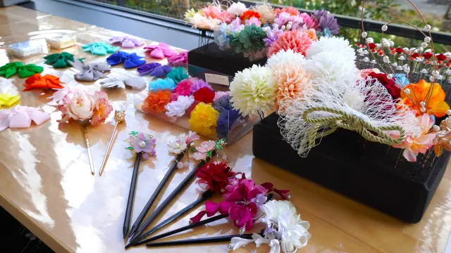 Vibrant hair ornaments, though small, add a stylish accent.