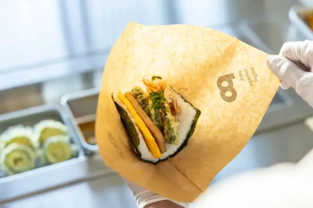 Enjoy freshly made rice balls, served hot.