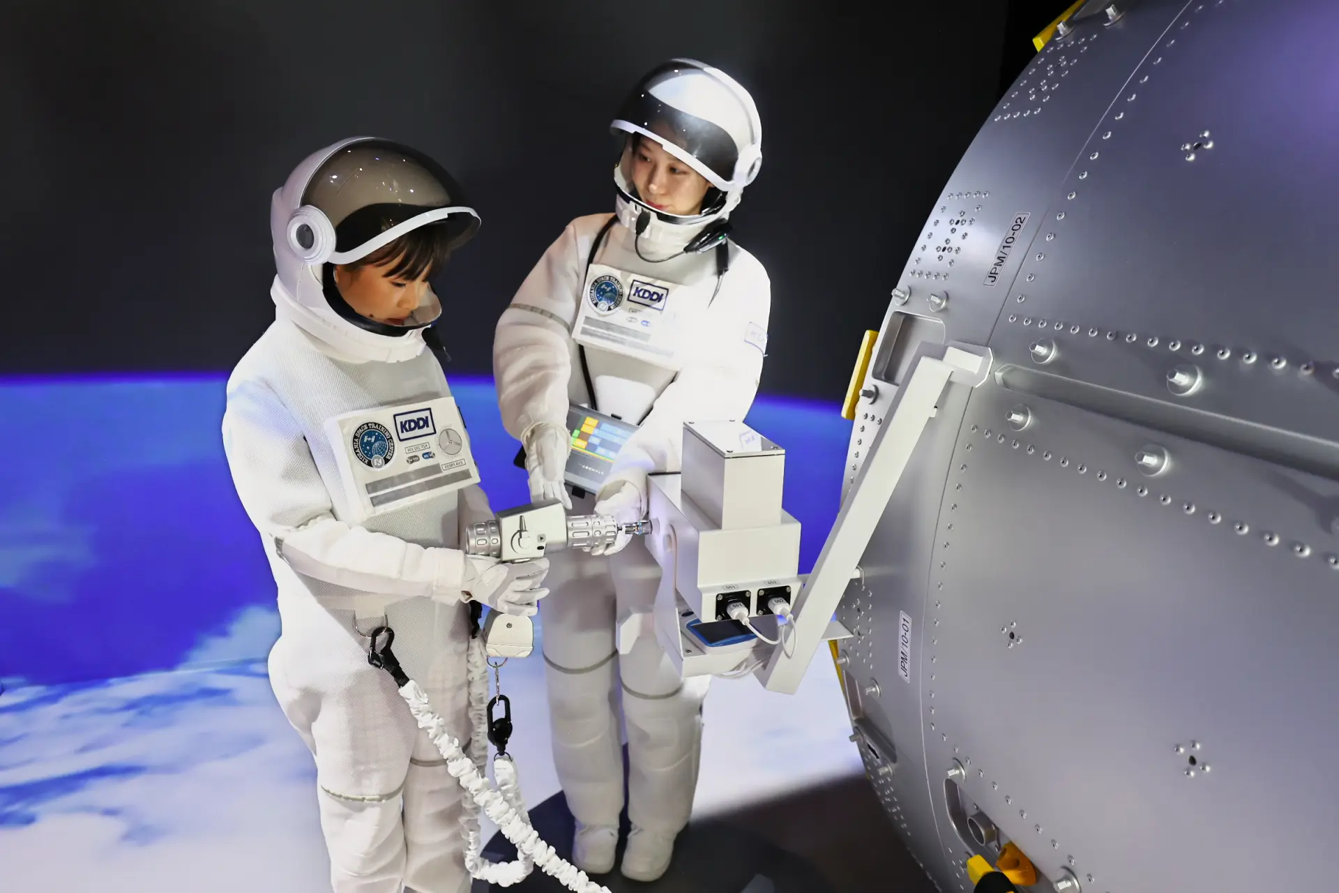 Astronauts replacing a camera