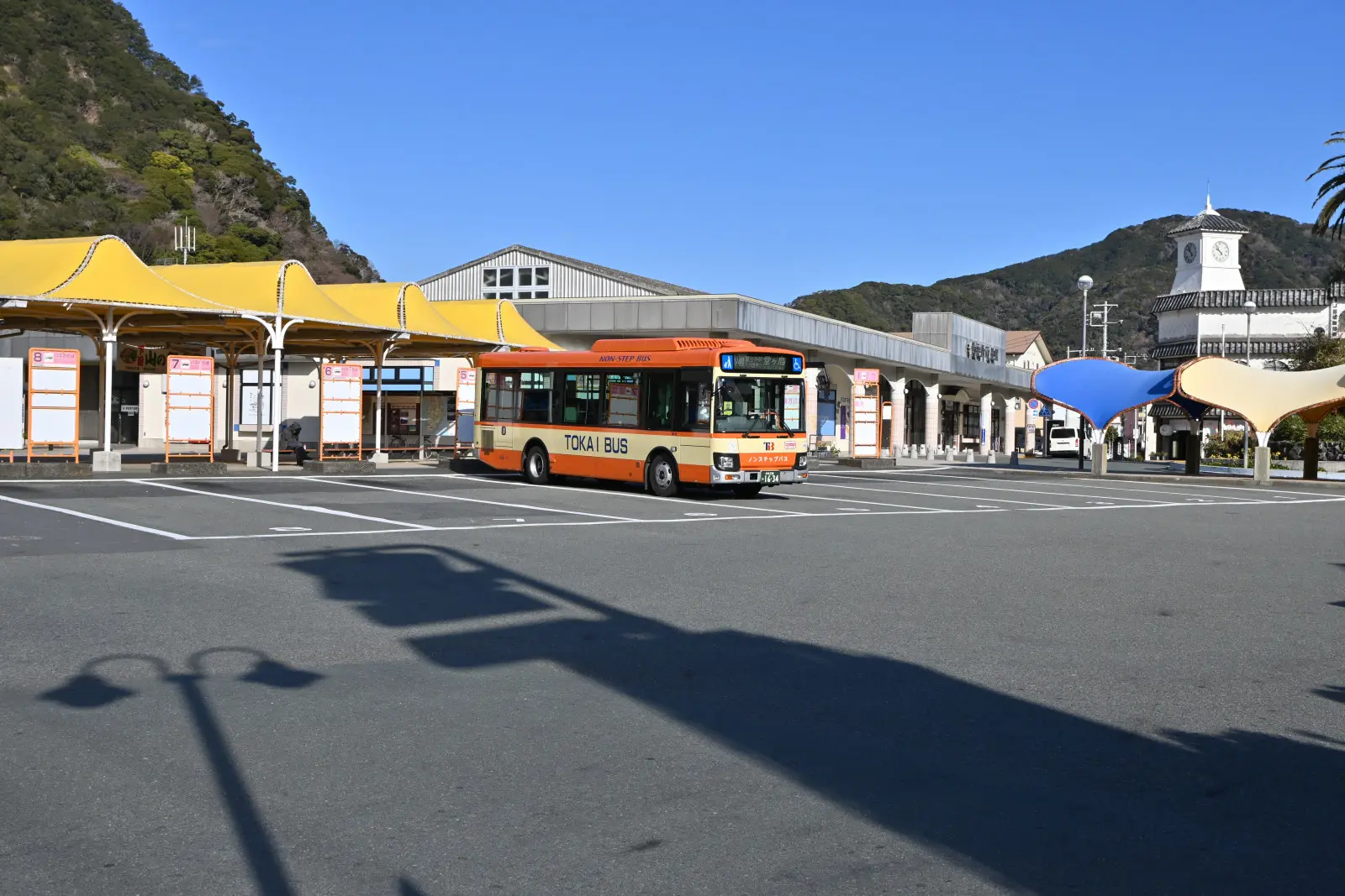 バス停は駅舎のすぐ隣にある。黄色の日除け屋根が目印
