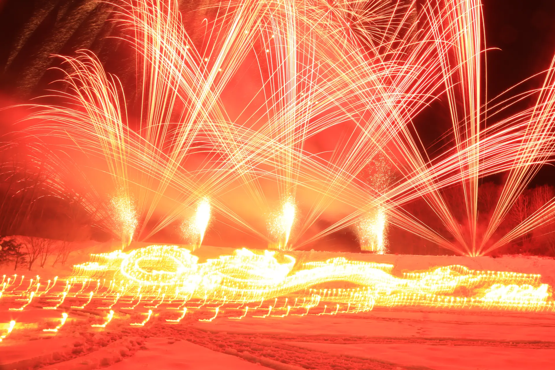 将冬夜长空与雪原染上明亮光彩的烟火