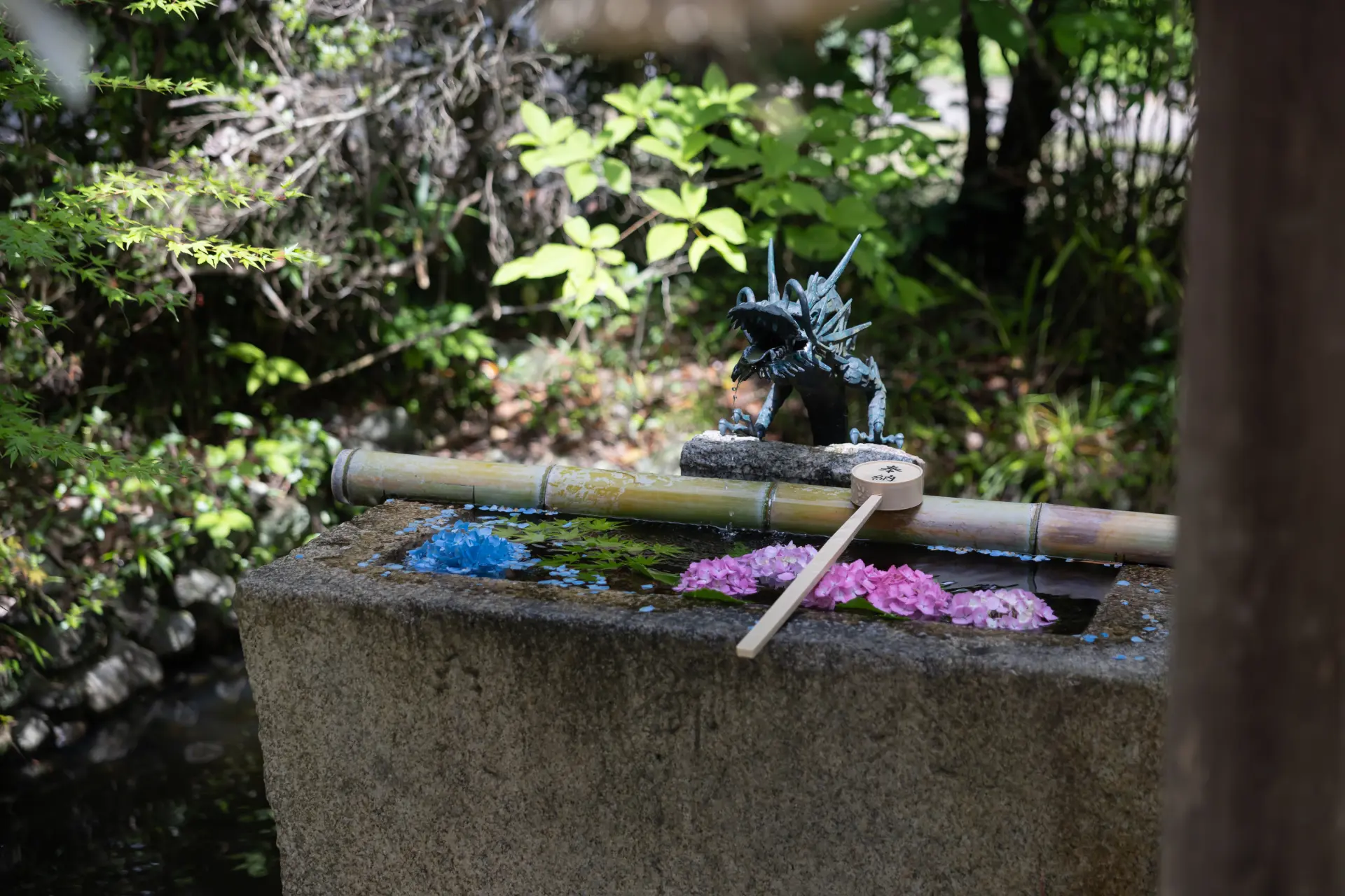 Seasonal flowers decorate the temizuya purification pavilion, delighting visitors to the shrine.