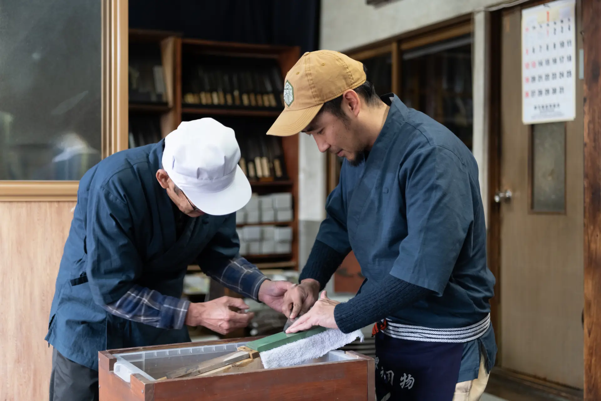職人の指導を受けながら、包丁の研ぎに挑戦