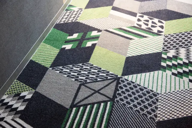Carpeting inspired by traditional Japanese patterns, with green tones that evoke moss