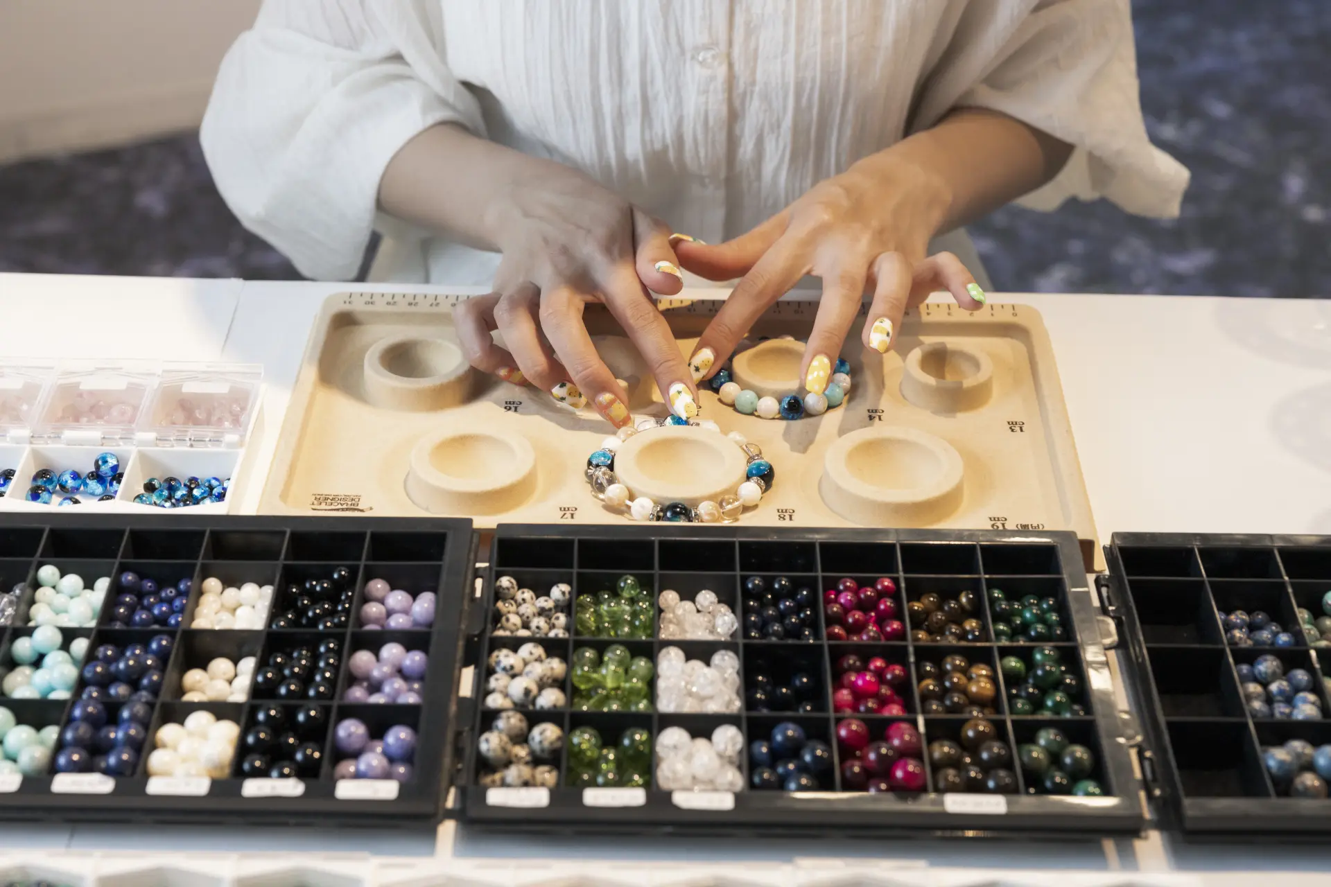 Choosing your favorite components in a bracelet-making workshop