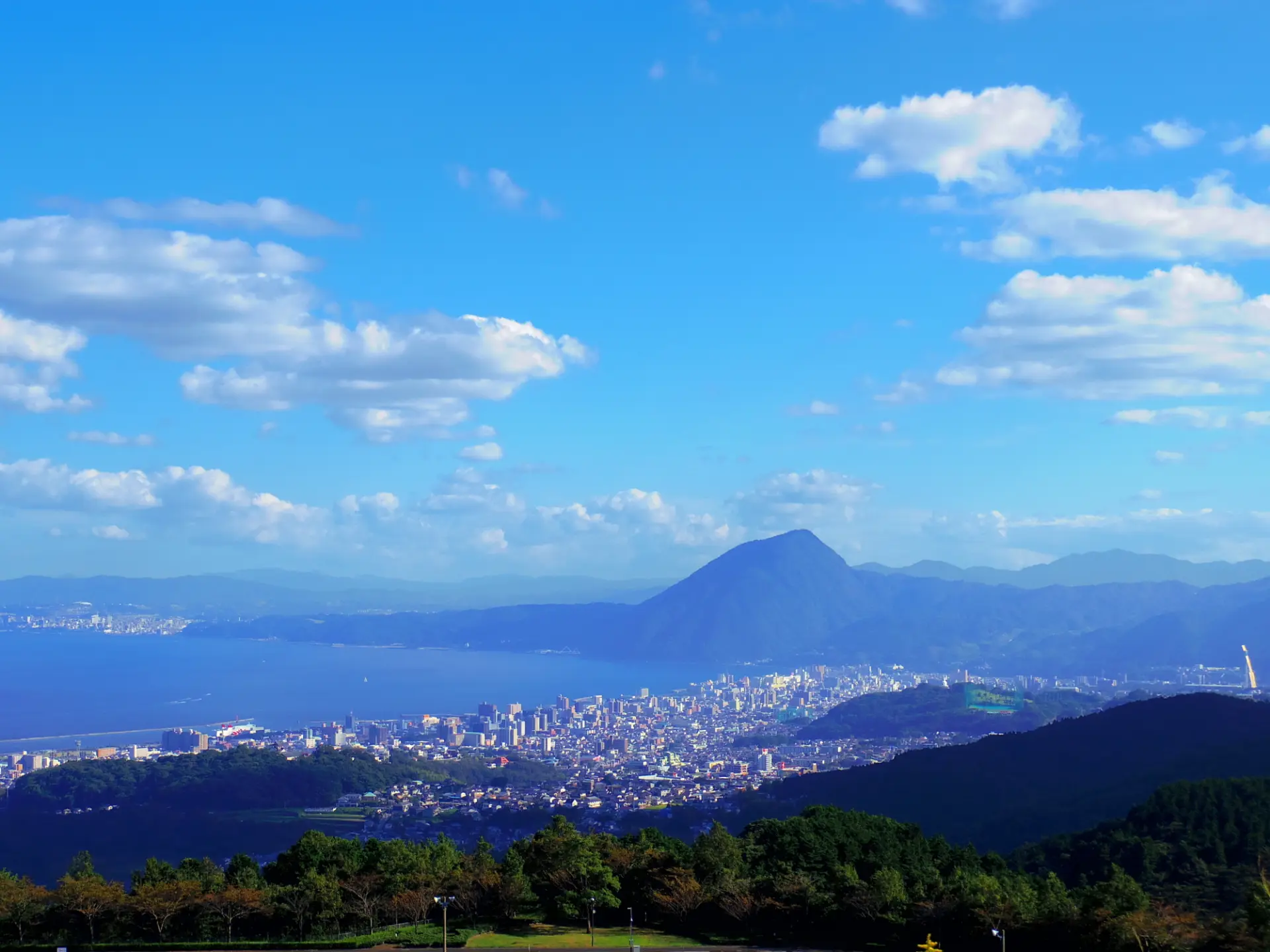 Views of Beppu Bay and Mount Yufu unfold beyond the cityscape of Beppu