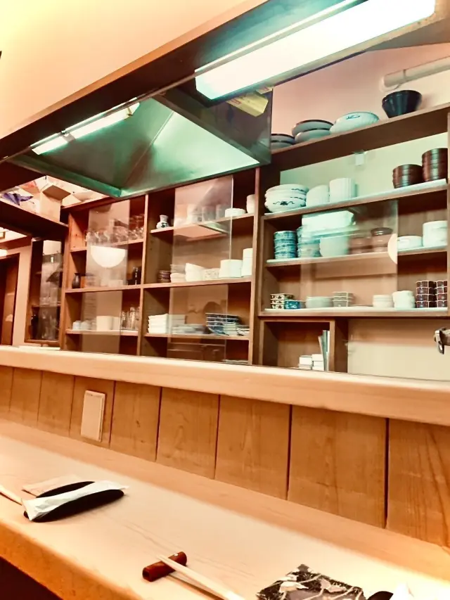 Counter seats offering a captivating view of the chef's graceful knife work