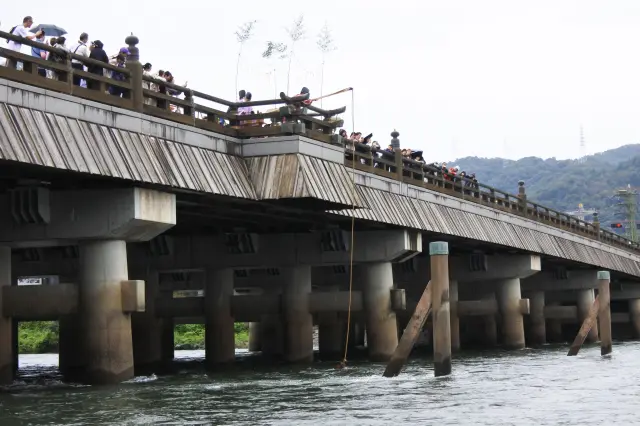 The Ceremony of Drawing Famous Water at the San-no-ma section of Uji Bridge