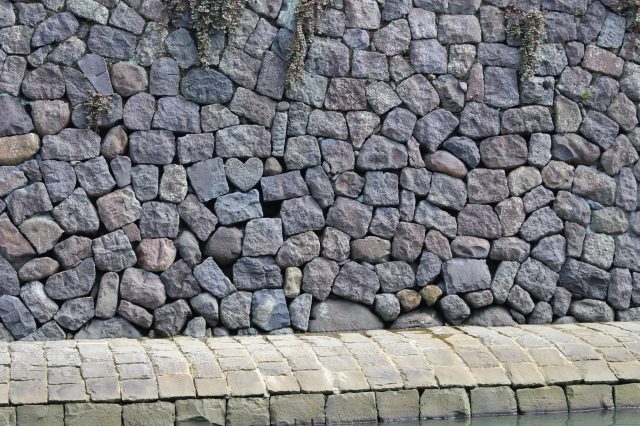 The heart-shaped rock on wall stone at Meganebashi Brigde in Nagasaki,  Japan Photos